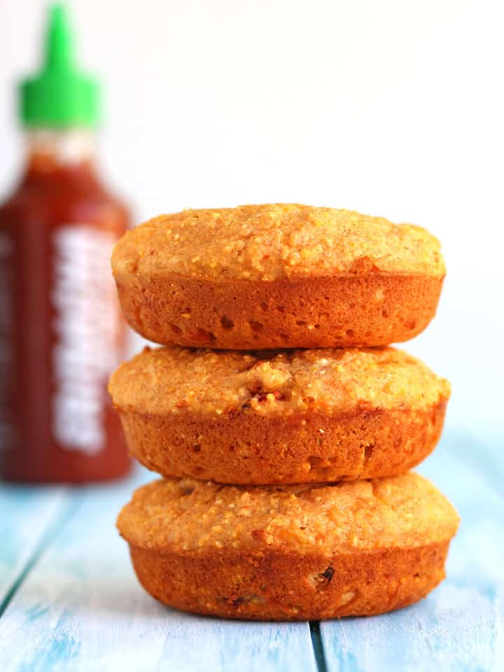Cheddar Sriracha Cornbread Donuts. A flavorful blend of hearty cornmeal, whole wheat flour, spicy sriracha sauce and cheddar cheese. Perfect as an afternoon snack or dunked in a warm bowl of vegetarian chili. 