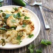 Jalapeño Roasted Cauliflower. A mildly spicy healthy vegetable side dish for two. Crispy jalapeño slices with rich buttery roasted cauliflower.
