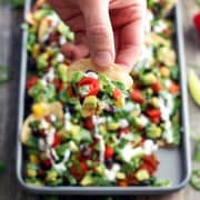 Toaster Oven Veggie Nachos. Crunchy tortilla chips topped with shredded pepper jack cheese, black beans and lots of crispy fresh veggies. Quickly bake up a small batch of nachos in your toaster oven today!