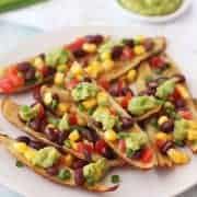 Potato skin strips on a plate with bean salsa and guacamole.